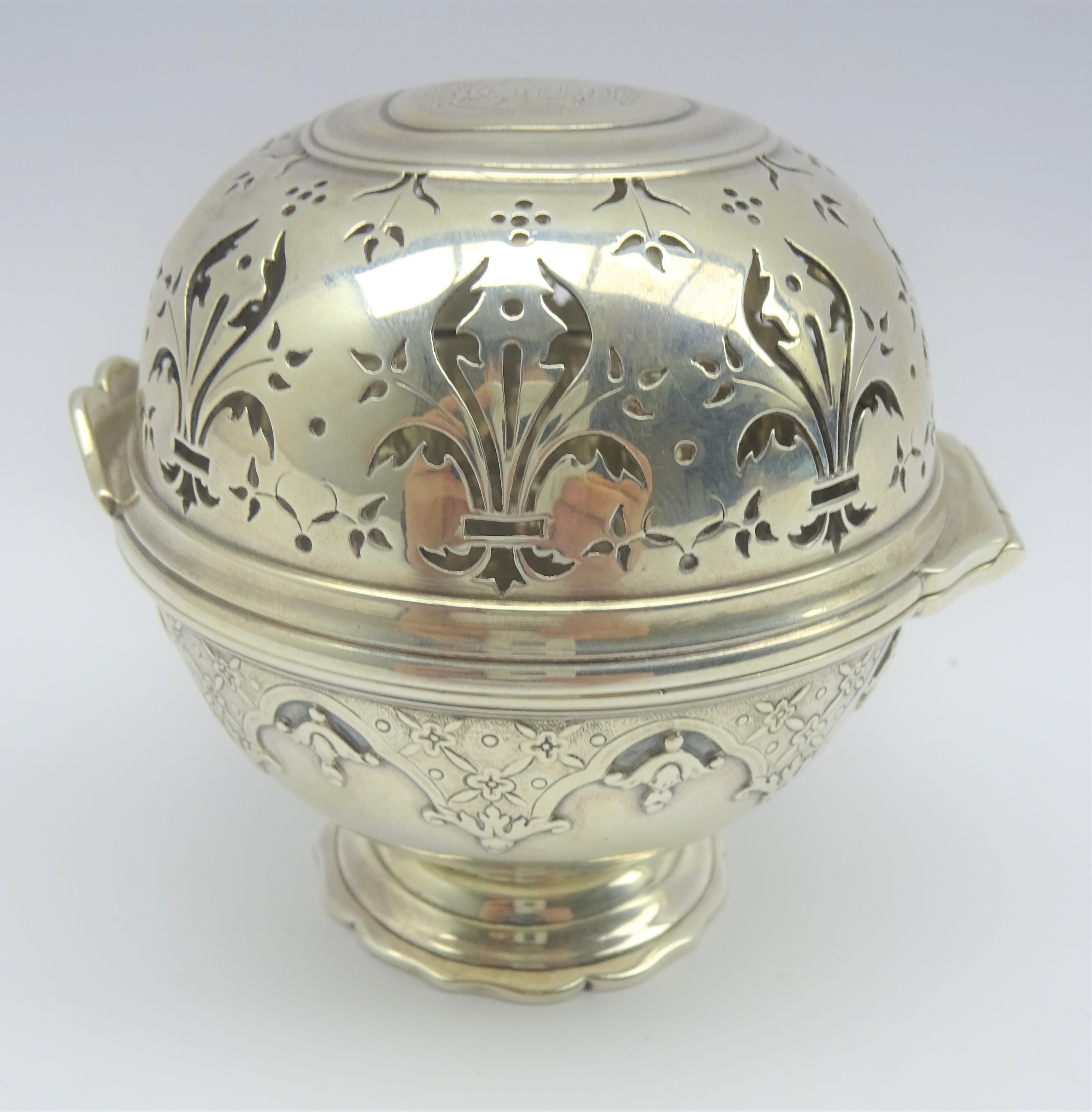 French silver sponge box of circular design with pierced cover and engraved with a coat of arms on