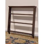 20th century stained pine three tier wall hanging plate rack, W106cm,