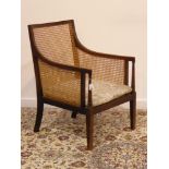 Early 20th century mahogany framed bergere armchair, upholstered loose seat cushion,