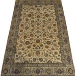 Persian Kashan ivory ground rug, interlacing floral design with orange highlights,