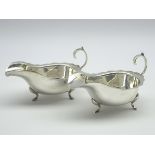 Pair of silver sauce boats with 'C' scroll handles on shaped supports Sheffield 1934 6.