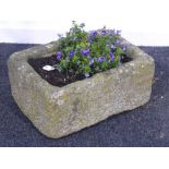 Rectangular weathered stone with hand hewn sides, planted,