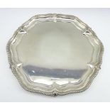 Silver circular salver with bead edge decoration on claw and ball feet 31cms Diam Sheffield 1921,