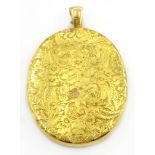 Gold pendant locket with engraved decoration, stamped 18ct approx 24.