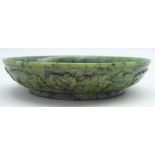Chinese spinach jade circular dish with carved decoration and Quianlong 4-character mark 10cms