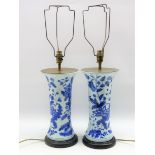 Pair of Chinese design vase column table lamps decorated in blue and white and with pleated shades