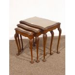 Mid 20th century figured walnut nest of tables fitted with inset glass tops,