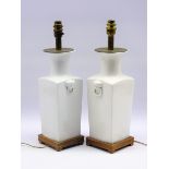 Pair of Chinese design square section white glazed table lamps on wooden bases H 33cms