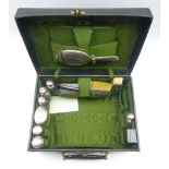 Ladies leather travelling dressing case with watered silk interior containing hammered silver