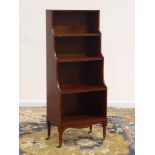 20th century mahogany four tier narrow open waterfall bookcase, turned supports with castors, W51cm,