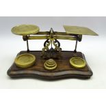 Victorian brass postal scales on serpentine fronted stained beech base,