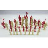 Chinese export carved ivory chess set circa 1900, red stained and natural white,