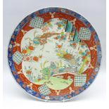 Japanese charger decorated with animals, flowers etc in orange,