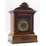Late 19th century walnut architectural cased bracket clock, arched pediment with carved detail,