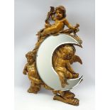 Stained pine wall bracket carved in relief with winged cherubs seated around a bevelled edge