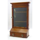 Late Victorian walnut spoon rack, enclosed by glazed door, single drawer, moulded glass handles,