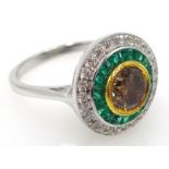 18ct white gold emerald, white and yellow diamond circular ring, stamped 750,
