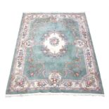 Large Chinese washed woollen rug carpet, pale mint ground, decorated with flowers and scrolls,