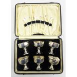 Cased set of 6 silver chalice shape pedestal cups engraved with cockerells and 6 mother of pearl
