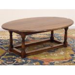 Medium oak coffee table, oval drop leaf top, turned supports with stretchers, 138cm x 93cm,