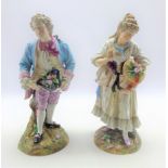 Pair of late 19th Century Continental porcelain standing figures of a Dandy and his lady,