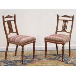 Pair Edwardian rosewood salon bedroom chairs, pierced backs inlaid with ribbons and trumpets,