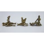 Three miniature cast metal erotic sculptures,