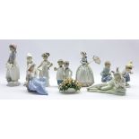 Nine Nao figures including a girl with parasol, kneeling girl with lamb,