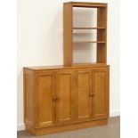Craftsman made oak sideboard, raised two tier shelves above four panelled cupboard doors,