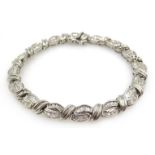 White gold baguette and round brilliant cut diamond bracelet, tested 14ct,