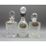 Cut crystal decanter with silver mount and two other crystal decanters,