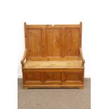 20th century polished pine pew/hall bench, high panelled back, hinged seat with storage, W122cm,