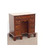 George III mahogany dog kennel desk, crossbanded top, fitted with seven oak lined drawers,