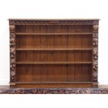 Victorian heavily carved oak open bookcase, three adjustable shelves, decorated with leaf carving,
