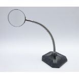 Industrial desk top magnifying glass with chrome gooseneck stem on cast iron base,