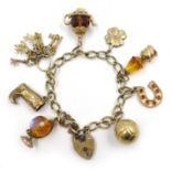9ct gold curb link bracelet with eight 9ct gold charms including football, clover, keys, globe etc,