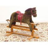 Contemporary child's rocking horse, on polished pine trestle base,