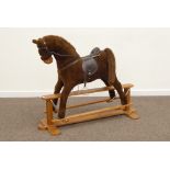'Mammas & Pappas' rocking horse with saddle, stirrups and reigns, stained wood trestle base,