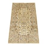 Persian Kashan rug, ivory ground decorated with interlacing foliate with stylised motifs,