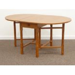 'Lizardman' oak drop leaf dining table, drawer to each end, on gate-leg action base,