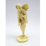 Japanese Meiji Period carved ivory Okimono of a man collecting wood, signed to base,