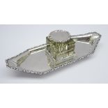 Edwardian silver inkstand with scroll edge decoration and with a square glass block inkwell