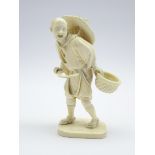 Japanese Meiji Period carved ivory Okimono of a market trader with a basket of vegetables and