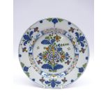 18th Century English Delft plate decorated with stylised flowers in blue, green and red,