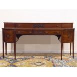 Regency mahogany sideboard, curved and canted break front top,