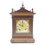 Late 19th century oak bracket clock, arched top with triple final pediment,