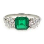 Platinum (tested) three stone diamond and emerald ring, diamonds approx 0.