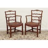 Pair of Georgian mahogany elbow chairs, waved pierced ladder backs,