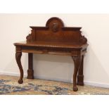 Late Victorian carved oak serving table, raised stepped arched back with centre crest 'C.