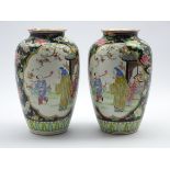 Pair of late 19th/ early 20th Century Oriental vases decorated with panels of figures surrounded by